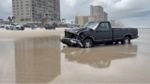 black chevy truck on beach